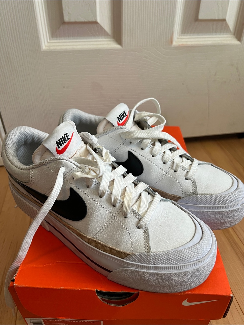 Nike Men’s White and Black Low-Top Sneakers with Red Logo Accents